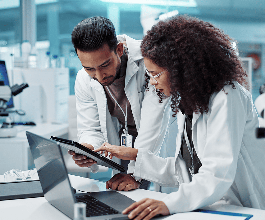 Two doctors researching medical devices and reviewing innovative healthcare technology